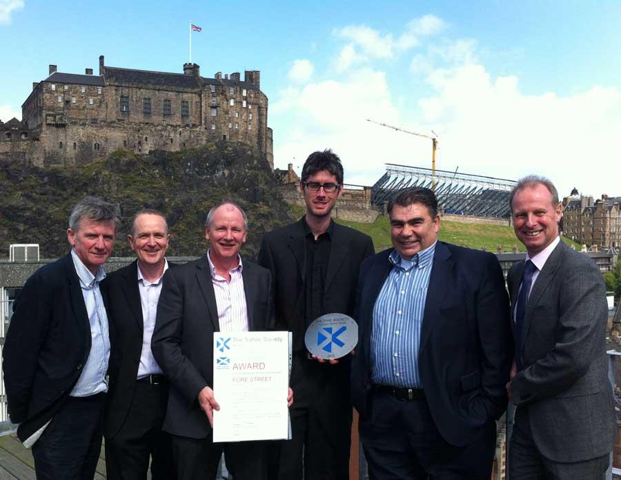 The Association proudly displaying the Saltire award in front of